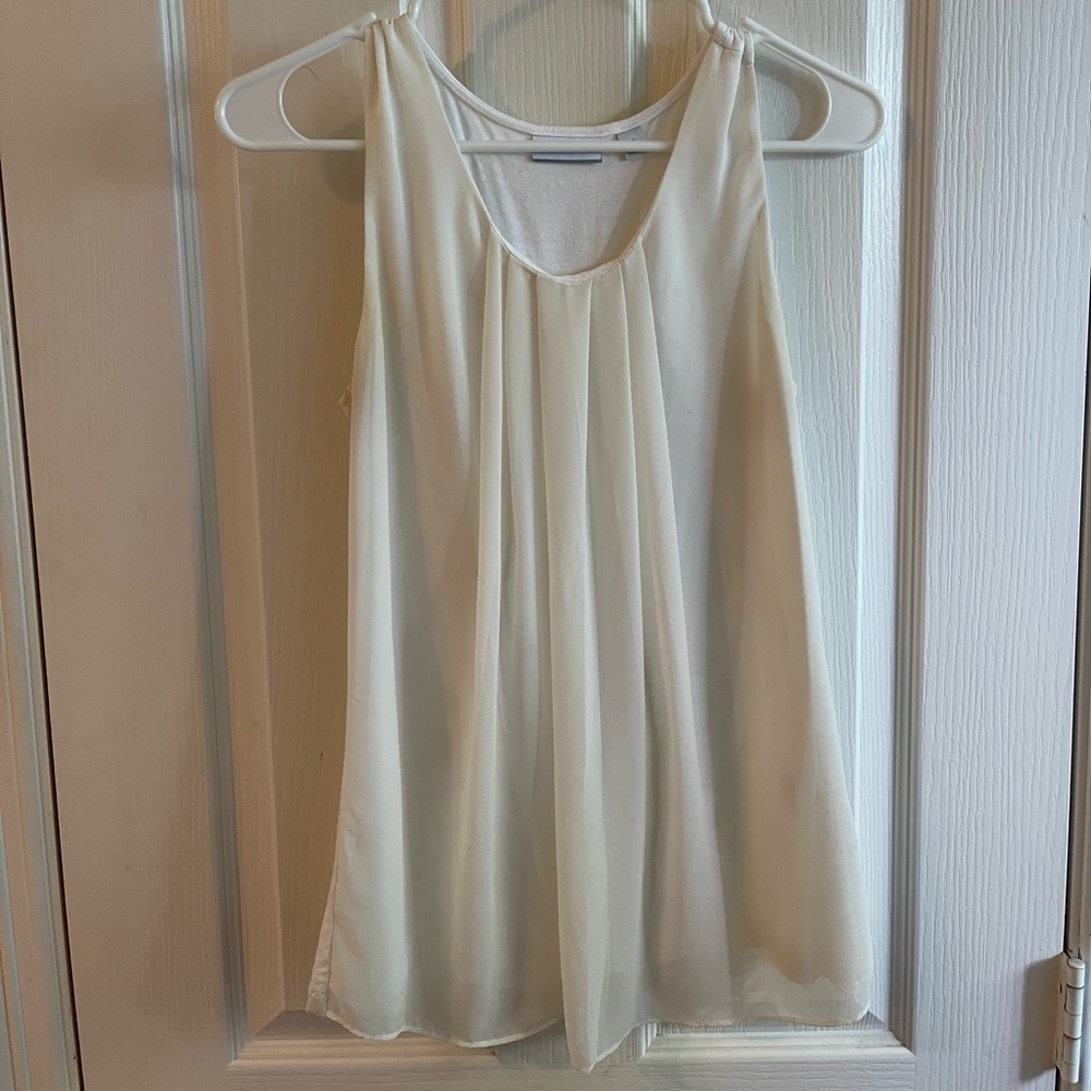 White sleeveless blouse with pleates